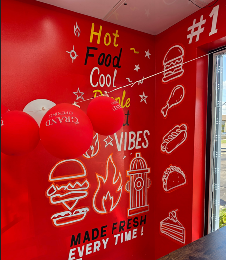 Hand-painted mural at Moe's Firehouse Kitchen reading Hot Food Cool People Made Fresh Every Time